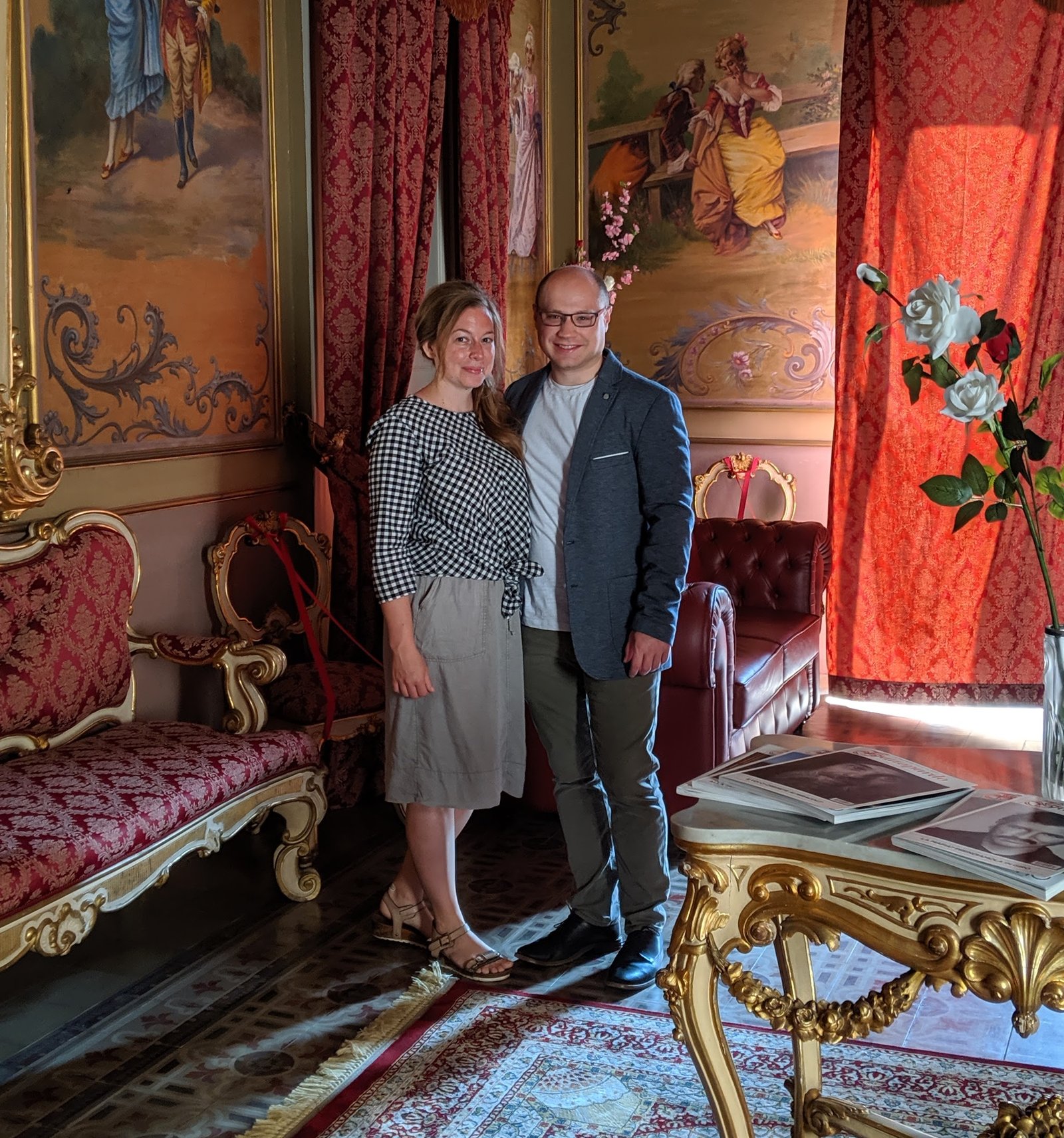 Jonathan and Jessica of Saturno Travel Co. in an ornate frescoed salon in Italy