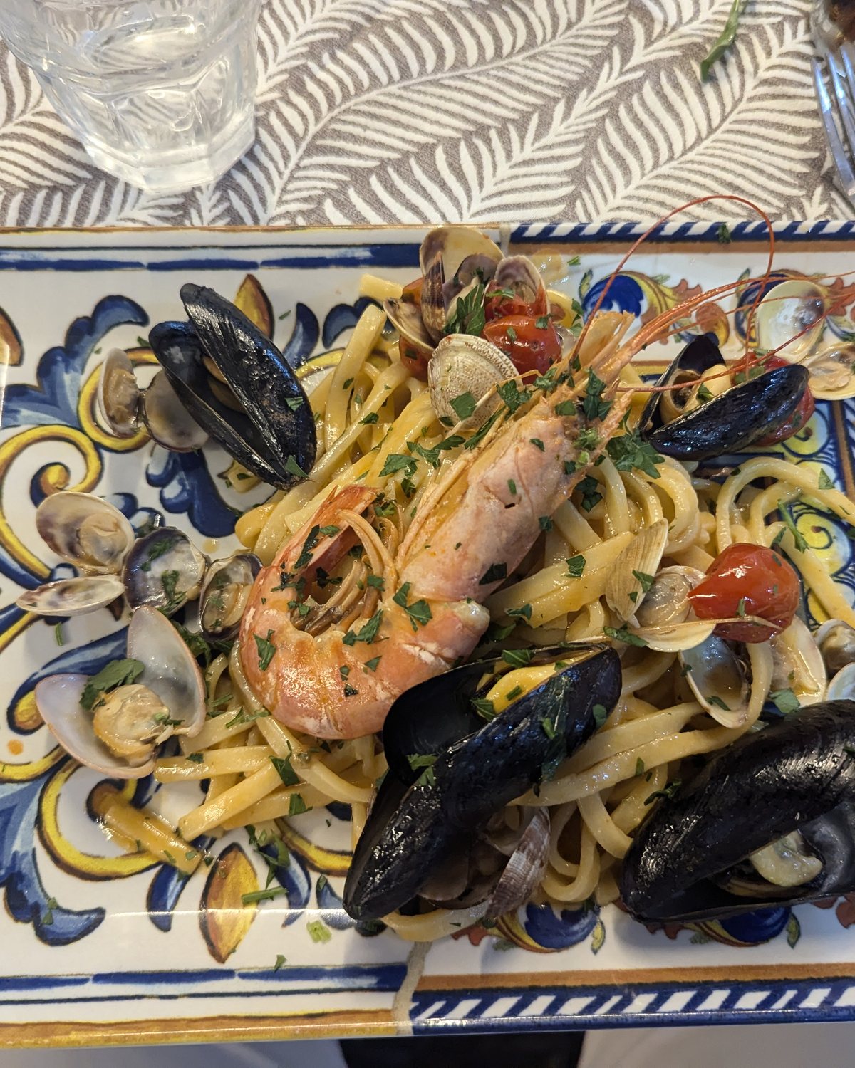 Seafood pasta served on a hand-painted majolica plate