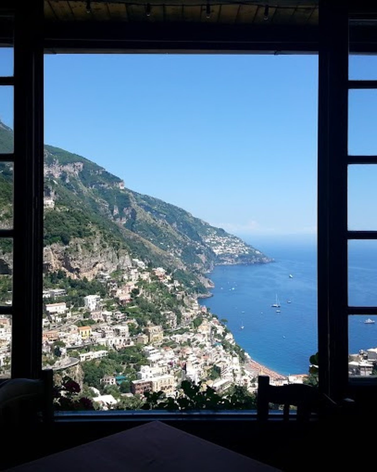 The Positano coastline seen through an open window